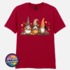 Three autumn gonks in tall pointed hats with pumpkins, a takeaway cup, a black cat and falling leaves printed on a unisex T-shirt antique cherry red - Print Unleashed