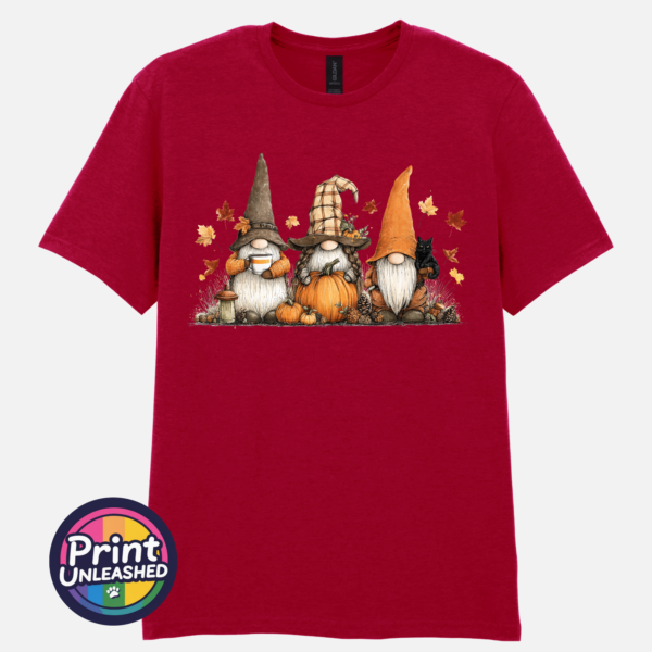 Three autumn gonks in tall pointed hats with pumpkins, a takeaway cup, a black cat and falling leaves printed on a unisex T-shirt antique cherry red - Print Unleashed