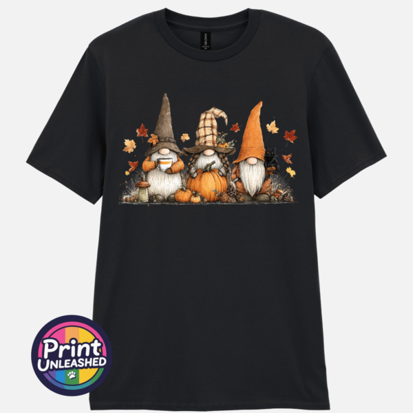 Three autumn gonks in witch hats with pumpkins, a takeaway cup, a black cat and falling leaves printed on a unisex T-shirt black - Print Unleashed