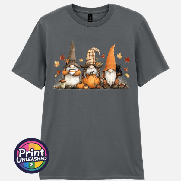 Three autumn gonks in witch hats with pumpkins, a takeaway cup, a black cat and falling leaves printed on a unisex T-shirt charcoal - Print Unleashed