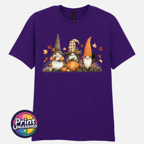 Three autumn gonks in witch hats with pumpkins, a takeaway cup, a black cat and falling leaves printed on a unisex T-shirt dark purple - Print Unleashed