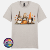 Three autumn gonks in witch hats with pumpkins, a takeaway cup, a black cat and falling leaves printed on a unisex T-shirt ice grey - Print Unleashed