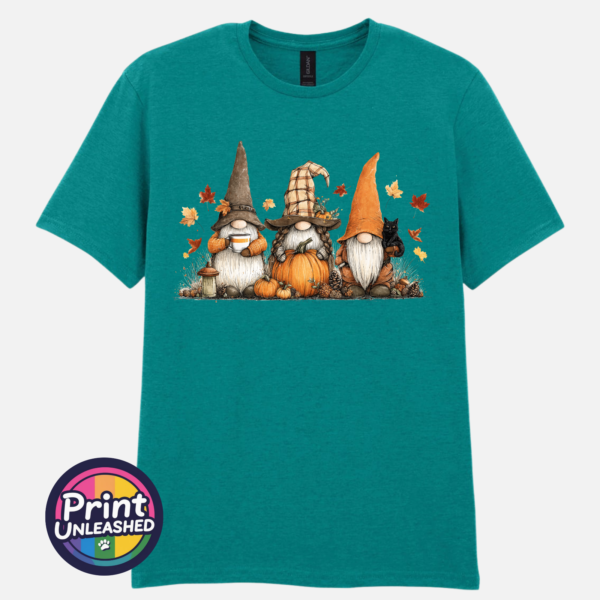 Three autumn gonks in witch hats with pumpkins, a takeaway cup, a black cat and falling leaves printed on a unisex T-shirt jade - Print Unleashed