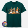 Three autumn gonks in witch hats with pumpkins, a takeaway cup, a black cat and falling leaves printed on a unisex T-shirt marine green - Print Unleashed