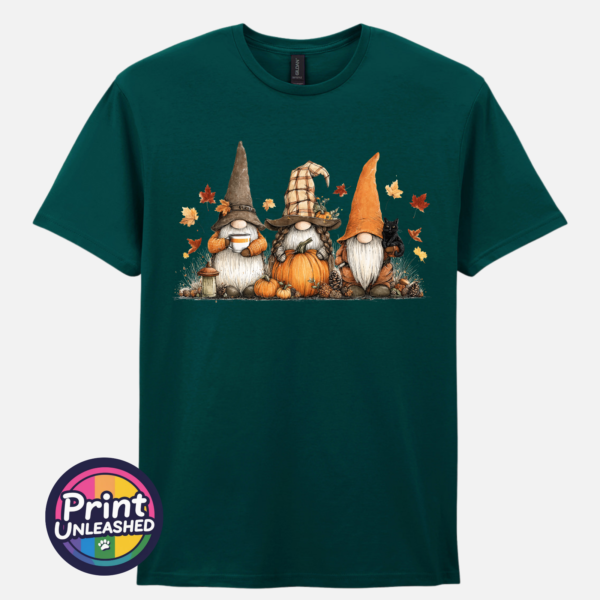 Three autumn gonks in witch hats with pumpkins, a takeaway cup, a black cat and falling leaves printed on a unisex T-shirt marine green - Print Unleashed
