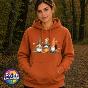 Three autumn gonks in tall pointed hats with pumpkins, a takeaway cup, a black cat and falling leaves printed on an orange softstyle hoodie model - Print Unleashed