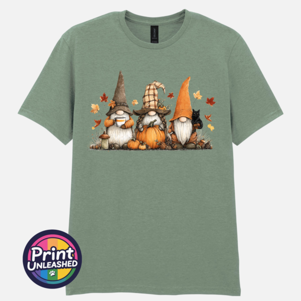 Three autumn gonks in witch hats with pumpkins, a takeaway cup, a black cat and falling leaves printed on a unisex T-shirt sage - Print Unleashed