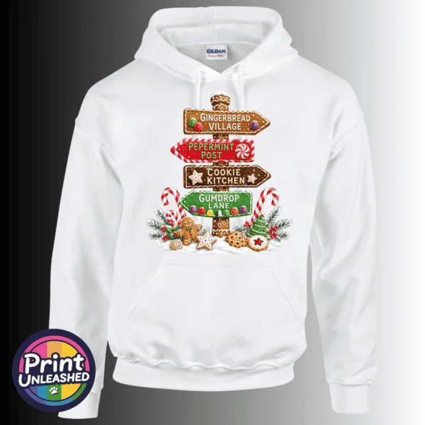 Gingerbread-style signpost pointing to Gingerbread Village, Peppermint Post, Cookie Kitchen and Gumdrop Lane, with sweets and biscuits, printed on a white unisex hoodie - Print Unleashed