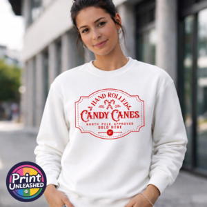 Vintage red Hand Rolled Candy Canes sign with crossed candy canes, holly, North Pole Approved wording and a five-cent emblem, printed on a white unisex sweatshirt female model - Print Unleashed