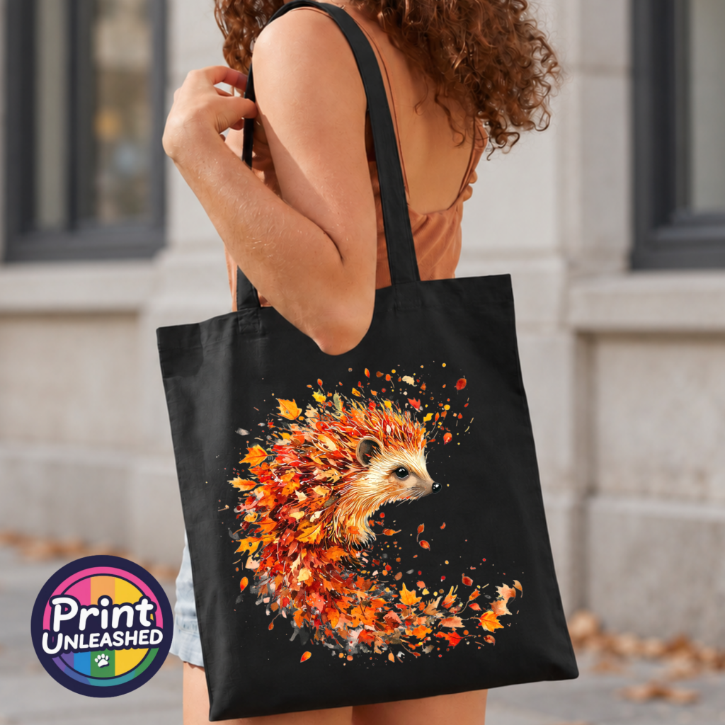 Hedgehog surrounded by swirling orange, red and golden autumn leaves on a black tote bag model - Print Unleashed