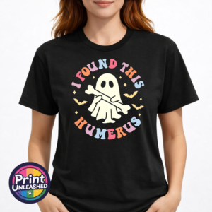 Cute ghost holding a bone beneath colourful I Found This Humerus lettering, surrounded by bats and stars, printed on a unisex T-shirt model - Print Unleashed