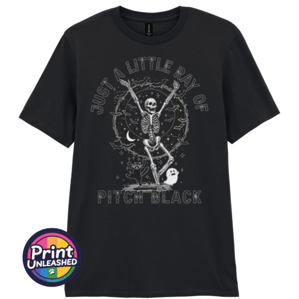 Just A Little Ray of Pitch Black black Black unisex T-shirt featuring a dancing skeleton with bats, a crescent moon, stars, a cat and ghost beneath Just a Little Ray of Pitch Black lettering - Print Unleashed