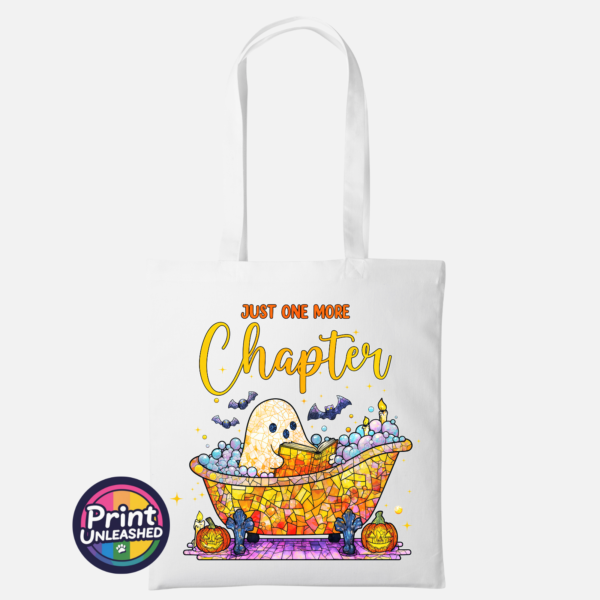 Just One More Chapter white Mosaic-style ghost reading in a colourful bubble bath surrounded by bats, candles and pumpkins, with Just One More Chapter wording, printed on a tote bag white - Print Unleashed