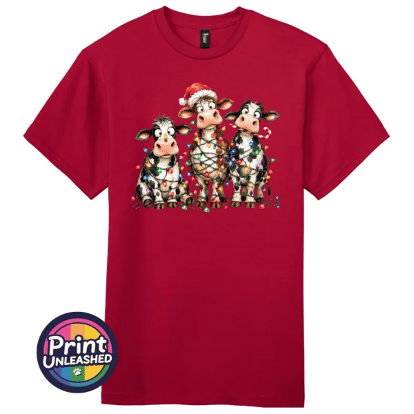 Lights tee Three Christmas cows tangled in colourful lights, one wearing a Santa hat and another holding a candy cane, printed on a cherry red premium unisex T-shirt - Print Unleashed