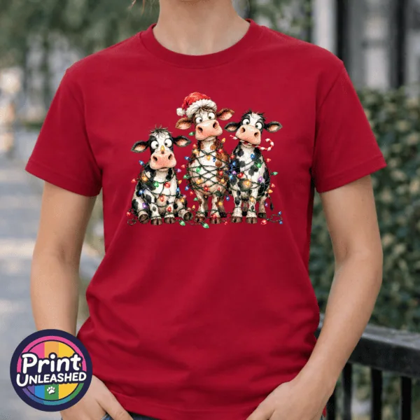 Lights tee model female Three Christmas cows tangled in colourful lights, one wearing a Santa hat and another holding a candy cane, printed on a cherry red premium unisex T-shirt female model - Print Unleashed