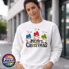 Three Christmas gonks in blue, red and green snow-topped hats above colourful patterned Merry Christmas lettering, printed on a white unisex sweatshirt female model - Print Unleashed
