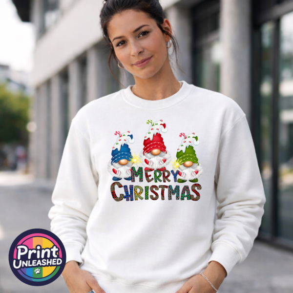 Merry Christmas Gonks sweat model female Three Christmas gonks in blue, red and green snow-topped hats above colourful patterned Merry Christmas lettering, printed on a white unisex sweatshirt female model - Print Unleashed