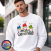 Three Christmas gonks in blue, red and green snow-topped hats above colourful patterned Merry Christmas lettering, printed on a white unisex sweatshirt male model - Print Unleashed