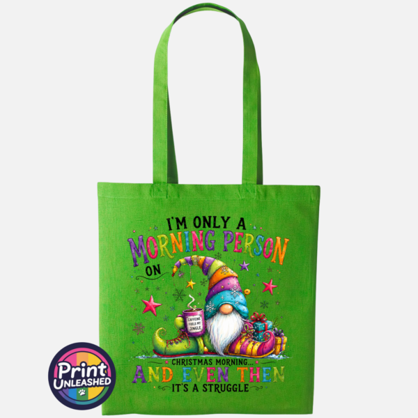Morning Person Gonk kiwi Colourful Christmas gonk holding a steaming coffee mug beside presents, with funny Christmas morning person wording, printed on a kiwi tote bag - Print Unleashed