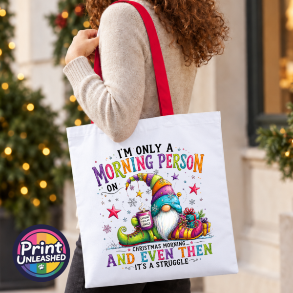 Morning Person Gonk model Colourful Christmas gonk holding a steaming coffee mug beside presents, with funny Christmas morning person wording, printed on a tote bag model - Print Unleashed