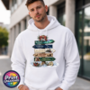Festive signpost with Northern Lights, observatory and reindeer destinations, decorated with bells, a sleigh and snowy details, printed on a white unisex hoodie male model - Print Unleashed