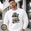 Festive signpost with Northern Lights, observatory and reindeer destinations, decorated with bells, a sleigh and snowy details, printed on a white unisex sweatshirt male model - Print Unleashed