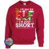 I’m not an elf I’m just short wording with red and green elf-style letters, striped stockings, holly and Christmas lights printed on a cherry red unisex sweatshirt - Print Unleashed