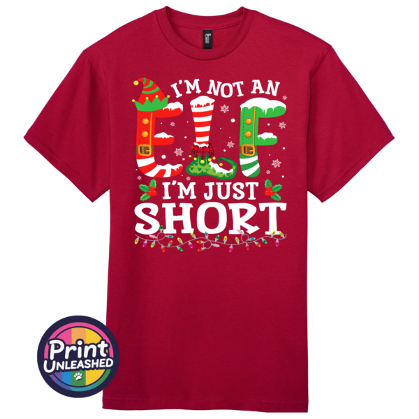 I’m not an elf I’m just short wording with red and green elf-style letters, striped stockings, holly and Christmas lights printed on a cherry red premium unisex T-shirt - Print Unleashed