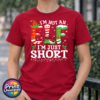 I’m not an elf I’m just short wording with red and green elf-style letters, striped stockings, holly and Christmas lights printed on a cherry red premium unisex T-shirt female model - Print Unleashed