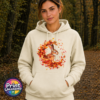 Rabbit framed by swirling red, orange and golden autumn leaves on a softstyle hoodie model - Print Unleashed