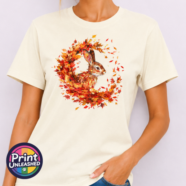 Rabbit off white model Rabbit framed by swirling red, orange and golden autumn leaves on an off-white unisex T-shirt model - Print Unleashed