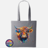 Highland cow portrait with a shaggy orange fringe, sweeping horns and vibrant blue, purple, yellow and green paint splashes printed on a tote bag graphite - Print Unleashed