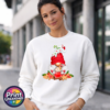 Christmas gonk in a red candy-cane-decorated hat holding a cream-topped cocoa mug, surrounded by iced biscuits, cinnamon and holly, printed on a white unisex sweatshirt female model - Print Unleashed