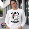 Cartoon sheep wearing a Santa hat and wrapped in colourful Christmas lights between Fleece Navidad wording, printed on a white unisex sweatshirt female model - Print Unleashed