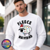 Cartoon sheep wearing a Santa hat and wrapped in colourful Christmas lights between Fleece Navidad wording, printed on a white unisex sweatshirt male model - Print Unleashed