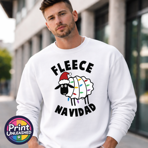 Sheep Fleece Navidad sweat male model Cartoon sheep wearing a Santa hat and wrapped in colourful Christmas lights between Fleece Navidad wording, printed on a white unisex sweatshirt male model - Print Unleashed