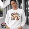 Three Christmas cows with reindeer antlers, earmuffs and signs reading Naughty or Nice and Santa’s Little Helper printed on a white unisex sweatshirt female model - Print Unleashed
