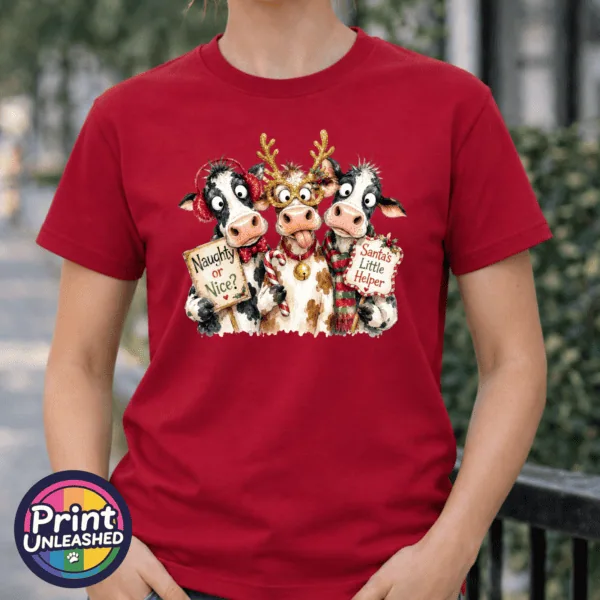 Three Christmas cows with antler glasses, earmuffs and Naughty or Nice and Santa’s Little Helper signs printed on a cherry red premium unisex T-shirt female model - Print Unleashed
