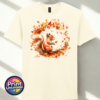 Red squirrel with a sweeping bushy tail surrounded by a swirl of orange, red and golden autumn leaves printed on a unisex T-shirt in off white - Print Unleashed