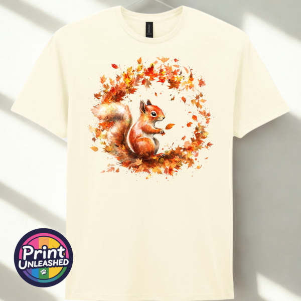 Squirrel off white Red squirrel with a sweeping bushy tail surrounded by a swirl of orange, red and golden autumn leaves printed on a unisex T-shirt in off white - Print Unleashed