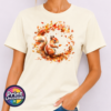 Red squirrel with a sweeping bushy tail surrounded by a swirl of orange, red and golden autumn leaves printed on a unisex T-shirt in off white model - Print Unleashed