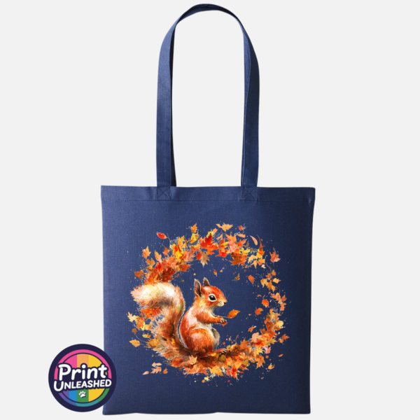 Red squirrel with a sweeping bushy tail surrounded by a swirl of orange, red and golden autumn leaves printed on a tote bag oxford navy - Print Unleashed