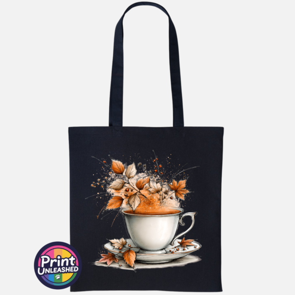 Teacup and saucer with copper and cream autumn leaves, berries and swirling orange steam printed on a tote bag black - Print Unleashed