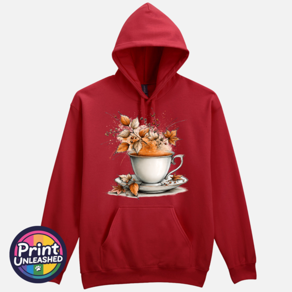 Teacup and saucer with copper and cream autumn leaves, berries and swirling orange steam printed on a softstyle hoodie in cardinal red - Print Unleashed
