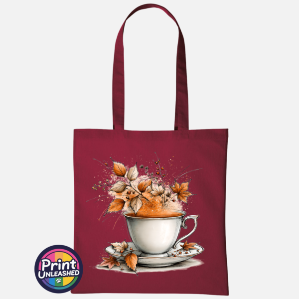 Teacup and saucer with copper and cream autumn leaves, berries and swirling orange steam printed on a tote bag deep red - Print Unleashed