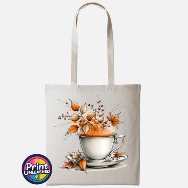 Teacup and saucer with copper and cream autumn leaves, berries and swirling orange steam printed on a tote bag natural - Print Unleashed