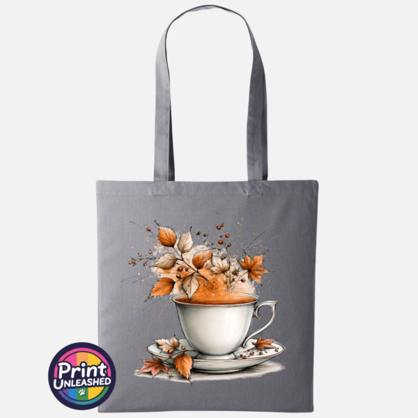 Teacup and saucer with copper and cream autumn leaves, berries and swirling orange steam printed on a tote bag slate - Print Unleashed