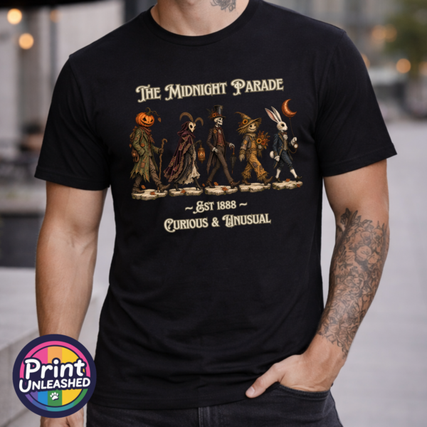 The Midnight Parade black model The Midnight Parade featuring a pumpkin-headed wanderer, horned masked figure, skeleton, scarecrow and rabbit with a crescent-moon balloon, printed on a unisex T-shirt model - Print Unleashed