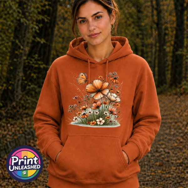 Copper, peach and cream wildflowers with delicate grasses and an orange butterfly printed on a softstyle hoodie model - Print Unleashed