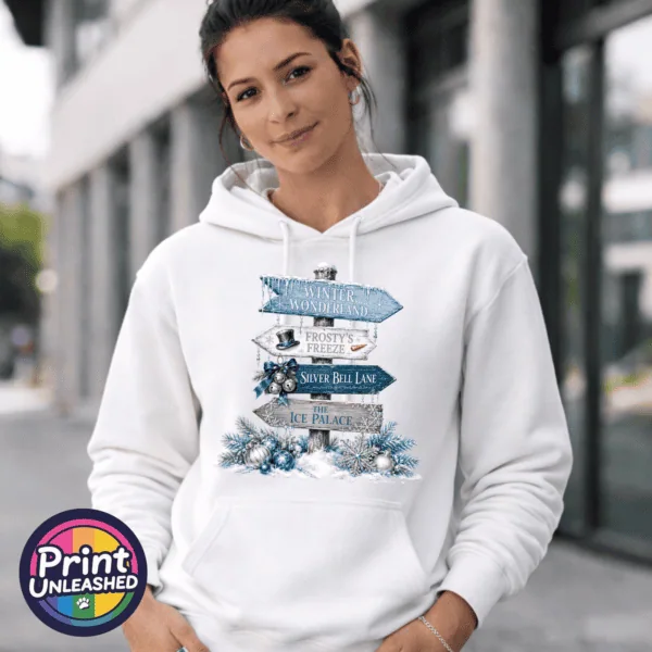 Winter Wonderland hoodie female Snow-covered signpost pointing to Winter Wonderland, Frosty’s Freeze, Silver Bell Lane and the Ice Palace, with blue and silver decorations, printed on a white unisex hoodie female model - Print Unleashed